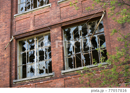 Closeup of broken windows on abandoned factory Closeup of broken windows on abandoned factory 77057816