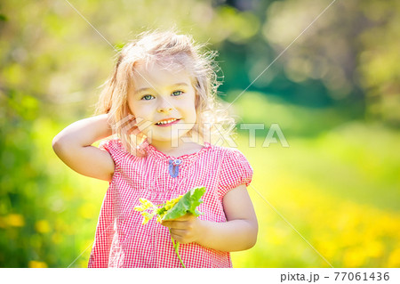 Happy little girl in spring sunny park Happy little girl in spring sunny park 77061436