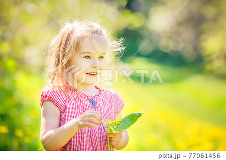 Happy little girl in spring sunny park Happy little girl in spring sunny park 77061456