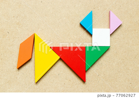 Color tangram puzzle in ox, buffalo or bull shape on wood background 77062927
