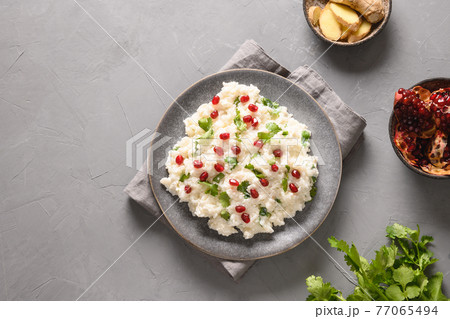 Curd Rice with pomegranate, cilantro, ginger on a grey background. Curd Rice with pomegranate, cilantro, ginger on a grey background. 77065494