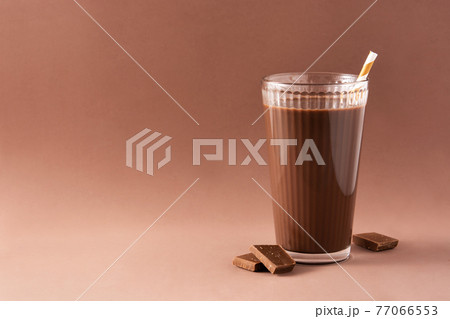 Chocolate milkshake in glass on brown background. Copy space 77066553