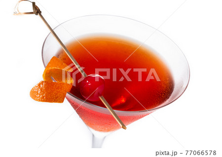 Traditional Manhattan cocktail with cherry isolated on white background Traditional Manhattan cocktail with cherry isolated on white background 77066578