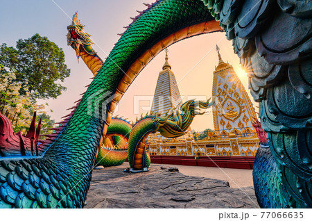 Rainbow carve serpent or colorful Thai Naga surrounding Sri Maha Pho Chedi stupa in the sunset at Wat Phra That Nong Bua Rainbow carve serpent or colorful Thai Naga surrounding Sri Maha Pho Chedi stupa in the sunset at Wat Phra That Nong Bua 77066635