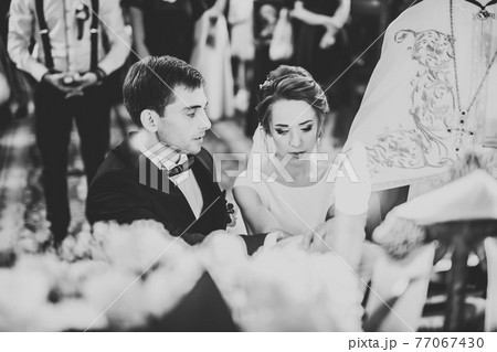 Wedding couple bide and groom get married in a church Wedding couple bide and groom get married in a church 77067430
