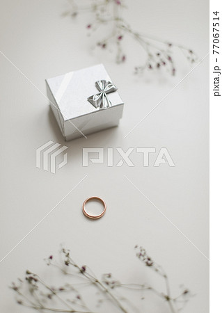Golden ring and jewelry box and flowers. Wedding, Love, Valentine's day, Happy Birthday, Proposal of marriage concept 77067514