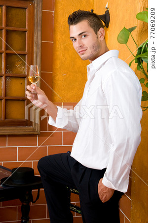 Flamenco dancer from Seville in Spain drinking a wine before dancing in a typical Spanish venue 77069209