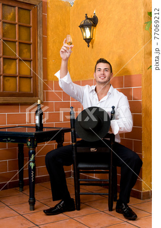 Flamenco dancer from Seville in Spain drinking a wine before dancing in a typical Spanish venue Flamenco dancer from Seville in Spain drinking a wine before dancing in a typical Spanish venue 77069212