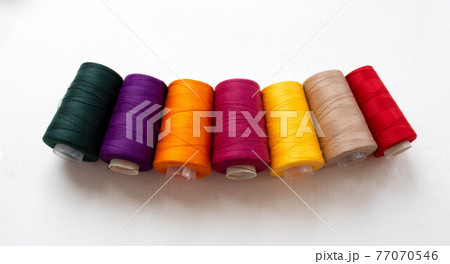 Panorama of colorful bobbins isolated on a white background Panorama of colorful bobbins isolated on a white background 77070546