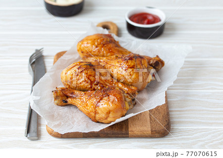 Roasted or grilled chicken legs drumsticks Roasted or grilled chicken legs drumsticks 77070615