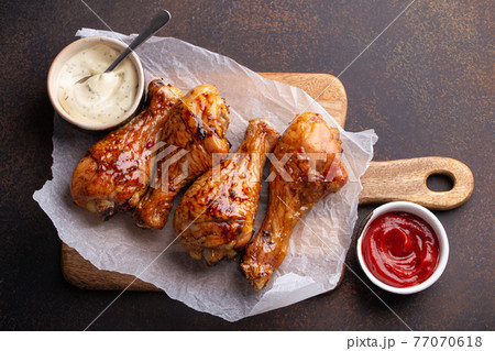 Roasted or grilled chicken legs drumsticks from above Roasted or grilled chicken legs drumsticks from above 77070618