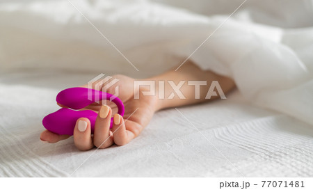 A faceless woman lies in bed under a blanket holding a clitoral vaginal vibrator. The girl masturbates A faceless woman lies in bed under a blanket holding a clitoral vaginal vibrator. The girl masturbates 77071481