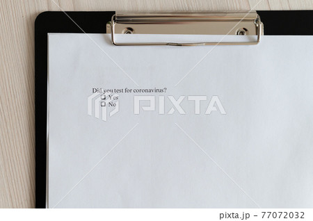Coronavirus test questionnaire and pen on the table. Checklist for questions about covid-19. Coronavirus test questionnaire and pen on the table. Checklist for questions about covid-19. 77072032