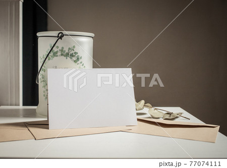 blank greeting card  invitation mockup with craft paper envelope  feminine still life composition 77074111