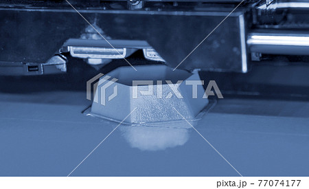 3d printer printing blue gray faceted geometric shapes blue background 3d printer printing blue gray faceted geometric shapes blue background 77074177