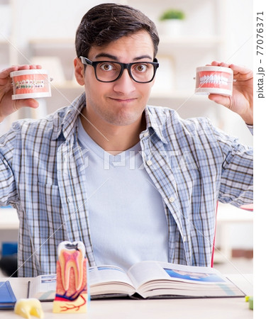 Medical student learning dentistry in classroom Medical student learning dentistry in classroom 77076371