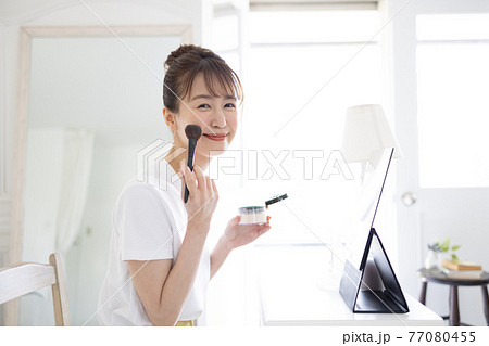 メイクするきれいな若い女性 77080455