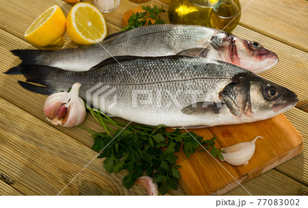 Sea basses on cutting board 77083002