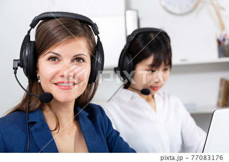 Portrait of woman helpline operator Portrait of woman helpline operator 77083176