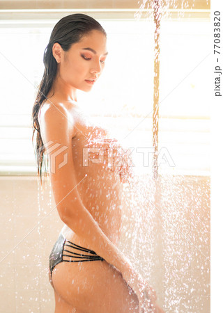 Attractive Sexy young woman enjoying shower with naked under water drops in bathroom. Attractive Sexy young woman enjoying shower with naked under water drops in bathroom. 77083820