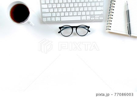 Modern white office desk table with keyboard computer, notebook, tree, glasses and cup of coffee. Top view with copy space, Modern white office desk table with keyboard computer, notebook, tree, glasses and cup of coffee. Top view with copy space, 77086003