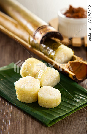 Glutinous rice is wrapped with lerek or banana leaf encased in bamboo culm and cooked in open fire / Lemang / A must have in every traditional Malay household, eaten with beef or chicken rendang 77092818