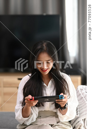 Chiang Mai Thailand. December 09, 2020. Young woman playing game on Nintendo Switch console. 77093516