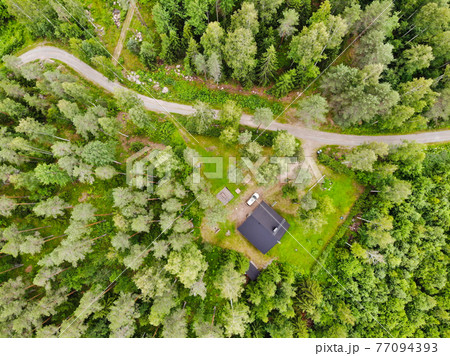 Aerial view of wooden cottage in green forest at rural summer in Finland 77094393