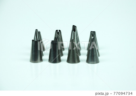 Sets of cream piping nozzles made from stainless steel isolated on white background. It is used to decorate cakes using cream.  77094734