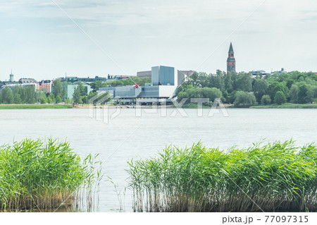 Helsinki, Finland - June 12, 2019: Toolo bay in the City Park in Helsinki, Finlandia Hall congress and event venue can be seen across the water Helsinki, Finland - June 12, 2019: Toolo bay in the City Park in Helsinki, Finlandia Hall congress and event venue can be seen across the water 77097315