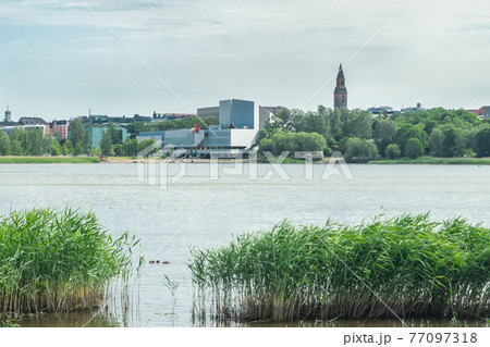 Helsinki, Finland - June 12, 2019: Toolo bay in the City Park in Helsinki, Finlandia Hall congress and event venue can be seen across the water 77097318