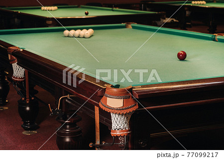 Billiard table with green surface and balls in the billiard club.Pool Game 77099217