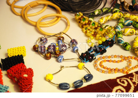 KUCHING, MALAYSIA -DECEMBER 07, 2016: Traditional Malaysian Sarawak ethnic woman accessories. Bracelets and necklaces made from made of special stones and animal skins. KUCHING, MALAYSIA -DECEMBER 07, 2016: Traditional Malaysian Sarawak ethnic woman accessories. Bracelets and necklaces made from made of special stones and animal skins. 77099651