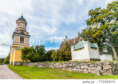 Hollola, Finland - 9 September 2019: Bell tower of old medieval stone church of St. Mary in Hollola, Finland Hollola, Finland - 9 September 2019: Bell tower of old medieval stone church of St. Mary in Hollola, Finland 77099874