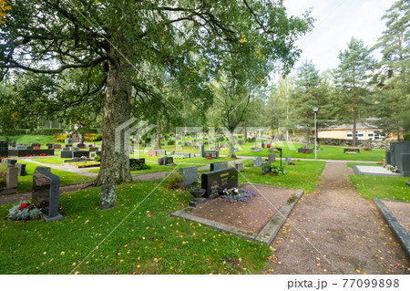 Hollola, Finland - 9 September 2019: Cemetery on the yard of old medieval stone church of St. Mary in Hollola, Finland 77099898