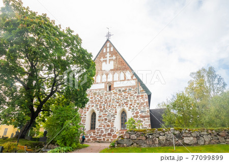 Hollola, Finland - 9 September 2019: Old medieval stone church of St. Mary in Hollola, Finland 77099899