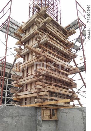 MALACCA, MALAYSIA -SEPTEMBER 19, 2016: Column timber form work and reinforcement bar at the construction site in Malacca, Malaysia. The structure supported by temporary wood support MALACCA, MALAYSIA -SEPTEMBER 19, 2016: Column timber form work and reinforcement bar at the construction site in Malacca, Malaysia. The structure supported by temporary wood support 77100646