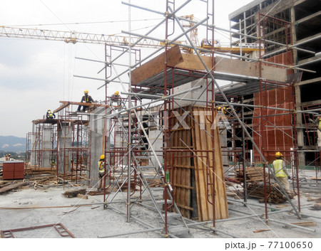 MALACCA, MALAYSIA -SEPTEMBER 19, 2016: Column timber form work and reinforcement bar at the construction site in Malacca, Malaysia. The structure supported by temporary wood support MALACCA, MALAYSIA -SEPTEMBER 19, 2016: Column timber form work and reinforcement bar at the construction site in Malacca, Malaysia. The structure supported by temporary wood support 77100650