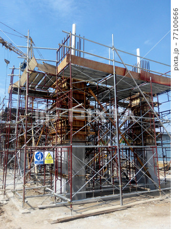 MALACCA, MALAYSIA -SEPTEMBER 19, 2016: Column timber form work and reinforcement bar at the construction site in Malacca, Malaysia. The structure supported by temporary wood support MALACCA, MALAYSIA -SEPTEMBER 19, 2016: Column timber form work and reinforcement bar at the construction site in Malacca, Malaysia. The structure supported by temporary wood support 77100666