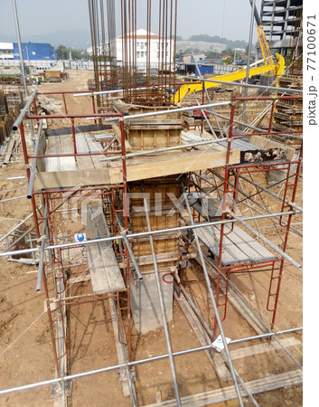 MALACCA, MALAYSIA -SEPTEMBER 19, 2016: Column timber form work and reinforcement bar at the construction site in Malacca, Malaysia. The structure supported by temporary wood support MALACCA, MALAYSIA -SEPTEMBER 19, 2016: Column timber form work and reinforcement bar at the construction site in Malacca, Malaysia. The structure supported by temporary wood support 77100671