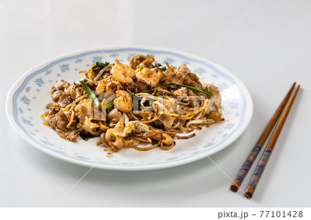 Serving of simple penang char kuey teow is popular fried noodle with coceral, shrimp and eggs in black sauce in Malaysia 77101428
