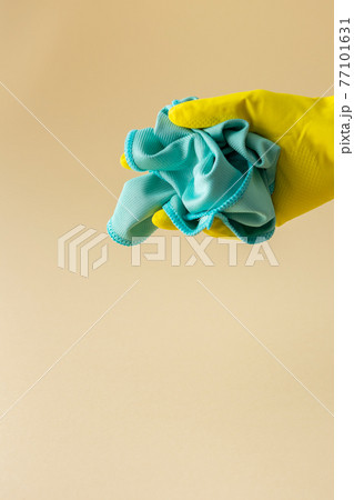 Hand in rubber glove holds microfiber cloth 77101631