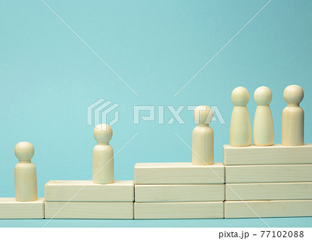 wooden figures of men on a ladder made of blocks. The concept of career advancement, starting at work, achieving goals wooden figures of men on a ladder made of blocks. The concept of career advancement, starting at work, achieving goals 77102088