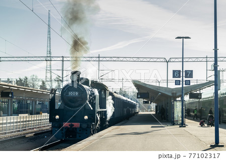 Kouvola, Finland - April 18, 2019: Old steam train Ukko-Pekka is leaving the station at morning. 77102317