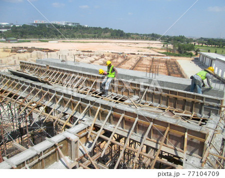 MALACCA, MALAYSIA -AUGUST 22, 2017: Fabrication work of building beam form work and reinforcement bar at the construction site in Malacca, Malaysia. MALACCA, MALAYSIA -AUGUST 22, 2017: Fabrication work of building beam form work and reinforcement bar at the construction site in Malacca, Malaysia. 77104709