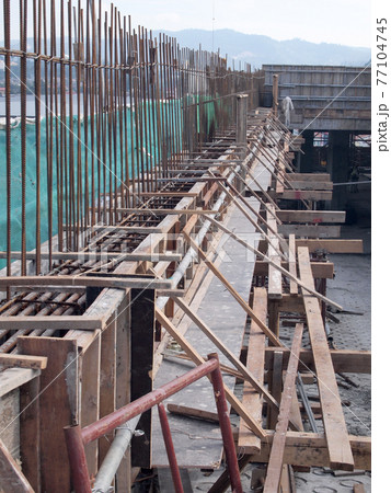 SELANGOR, MALAYSIA -FEBRUARY 20, 2017: Pile of used timber form work at the construction site. It will be demobilize from construction site to recycle or to dispose. SELANGOR, MALAYSIA -FEBRUARY 20, 2017: Pile of used timber form work at the construction site. It will be demobilize from construction site to recycle or to dispose. 77104745