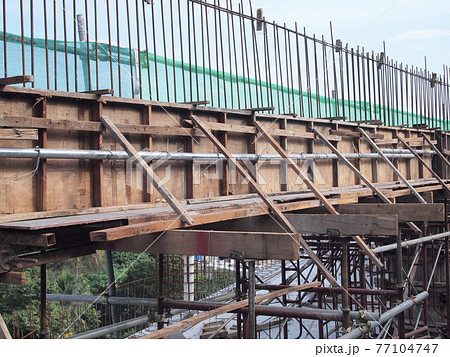 SELANGOR, MALAYSIA -FEBRUARY 20, 2017: Pile of used timber form work at the construction site. It will be demobilize from construction site to recycle or to dispose. SELANGOR, MALAYSIA -FEBRUARY 20, 2017: Pile of used timber form work at the construction site. It will be demobilize from construction site to recycle or to dispose. 77104747