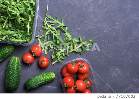 Fresh organic vegetables for healthy food cooking on dark background top view mock up Fresh organic vegetables for healthy food cooking on dark background top view mock up 77107002