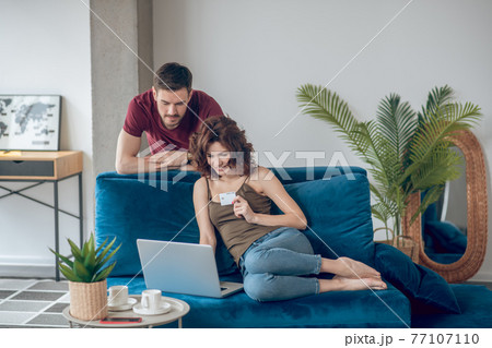 Couple making periodical payments online and looking involved 77107110