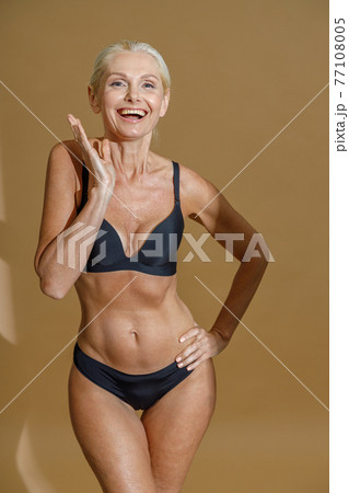 Studio shot of excited mature woman in black - Stock Photo [77108005] -  PIXTA